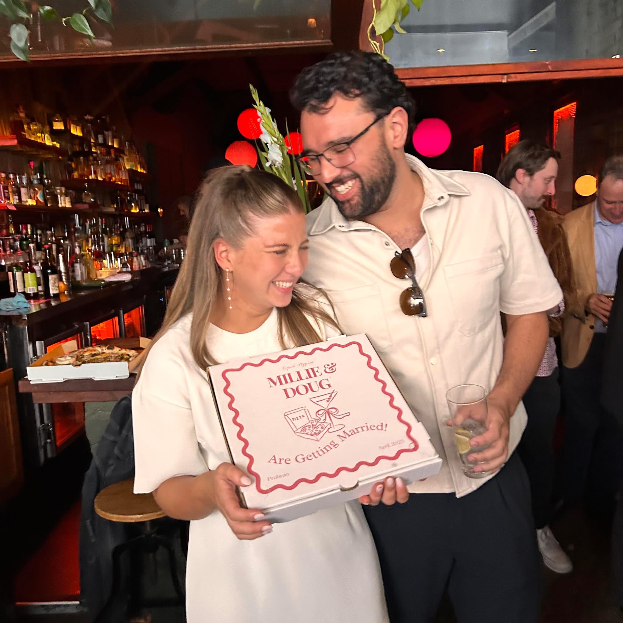 Doug and Millie laughing together at their engagement party